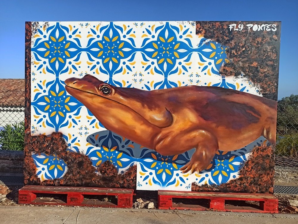 Mural "GeoPalcos 2021: Arte em Movimento" terminado. A obra combina a reconstituição do fóssil Metoposaurus Algarvensis, a textura do Grés de Silves e o padrão de azulejo, divulgando a candidatura do Geoparque Algarvensis da UNESCO.
